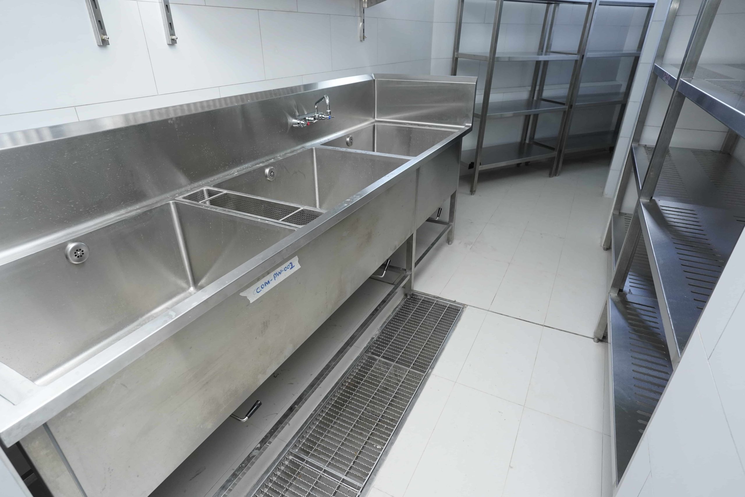 This image shows laundry equipment being installed in a commercial kitchen environment, ensuring reliable cleaning support for linens, uniforms, and kitchen textiles.